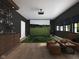 Spacious entertainment room featuring a golf simulator, custom bar, and comfortable leather seating at 1717 Beaufain St, Carmel, IN 46032