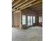 Unfinished living room featuring large windows and exposed studs showing the potential of the space at 1717 Beaufain St, Carmel, IN 46032