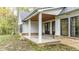 Covered back porch with double doors and wood ceiling at 4429 Village Dr, Anderson, IN 46012