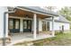 Farmhouse style back porch with double doors and ceiling fan at 4429 Village Dr, Anderson, IN 46012