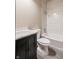 Simple bathroom with a white bathtub and dark vanity at 4429 Village Dr, Anderson, IN 46012