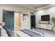Main bedroom with a barn door, TV, and access to bathroom at 4429 Village Dr, Anderson, IN 46012