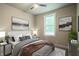 Bright bedroom with a queen bed, two nightstands, and natural light at 4429 Village Dr, Anderson, IN 46012