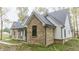 Brick and white farmhouse showcasing a side view at 4429 Village Dr, Anderson, IN 46012