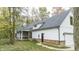 White and brick farmhouse with a rear view and attached garage at 4429 Village Dr, Anderson, IN 46012
