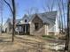 Brick and white farmhouse with a gray roof and covered porch at 4429 Village Dr, Anderson, IN 46012