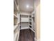 Spacious walk-in closet with built-in shelves and hanging rods at 4429 Village Dr, Anderson, IN 46012
