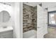 Updated bathroom with gray vanity and shower/tub combo at 628 N Beville Ave, Indianapolis, IN 46201