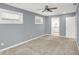 Spacious bedroom with ceiling fan and ensuite bathroom access at 628 N Beville Ave, Indianapolis, IN 46201