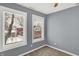 Well-lit bedroom with neutral walls and two windows at 628 N Beville Ave, Indianapolis, IN 46201