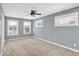 Spacious bedroom with gray walls, carpet, and ceiling fan at 628 N Beville Ave, Indianapolis, IN 46201