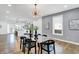 Bright dining room with glass table and black chairs, open to kitchen and living areas at 628 N Beville Ave, Indianapolis, IN 46201