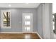 Bright entryway with hardwood floors and modern door at 628 N Beville Ave, Indianapolis, IN 46201