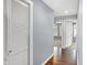 Gray hallway with wood flooring and access to bedrooms at 628 N Beville Ave, Indianapolis, IN 46201
