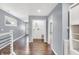 Gray hallway with laundry room and built-in shelving at 628 N Beville Ave, Indianapolis, IN 46201