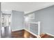 Gray hallway with dark hardwood floors and white railings at 628 N Beville Ave, Indianapolis, IN 46201