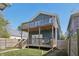 Two-story house with large deck and fenced yard at 628 N Beville Ave, Indianapolis, IN 46201