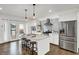 Modern kitchen with white cabinets, granite island, stainless steel appliances, and access to patio at 628 N Beville Ave, Indianapolis, IN 46201