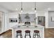 Modern kitchen with white cabinets, granite island with seating, stainless steel appliances at 628 N Beville Ave, Indianapolis, IN 46201