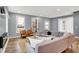 Spacious living room featuring a sectional sofa and hardwood floors at 628 N Beville Ave, Indianapolis, IN 46201