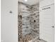 Walk-in shower with tile surround and pebble floor at 628 N Beville Ave, Indianapolis, IN 46201