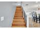 Wooden staircase with metal railings, view to kitchen at 628 N Beville Ave, Indianapolis, IN 46201