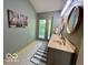 Updated bathroom with double vanity, outside deck access, and tile flooring at 6438 Pin Oak Dr, McCordsville, IN 46055