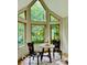 Bright breakfast nook with large windows offering a serene view of the surrounding greenery at 6438 Pin Oak Dr, McCordsville, IN 46055