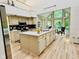 Spacious kitchen with center island, modern appliances, and breakfast nook with wooded views at 6438 Pin Oak Dr, McCordsville, IN 46055
