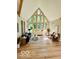 Bright living room boasts vaulted ceilings, large windows, and modern decor at 6438 Pin Oak Dr, McCordsville, IN 46055