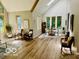 Open living room offering natural light from many windows and a vaulted ceiling at 6438 Pin Oak Dr, McCordsville, IN 46055