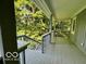 An open, covered porch with railing, wood flooring, and forest views at 6438 Pin Oak Dr, McCordsville, IN 46055