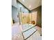 Modern walk-in shower with clear glass walls and a small bench at 6438 Pin Oak Dr, McCordsville, IN 46055