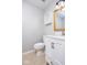 This powder room features toilet, vanity, and beige tile floors at 6072 Wingedfoot Ct, Indianapolis, IN 46254