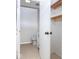 Bright bathroom featuring toilet, vanity, storage, and beige tile floors at 6072 Wingedfoot Ct, Indianapolis, IN 46254