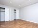 Bright bedroom featuring wood floors, neutral walls, and two closets at 6072 Wingedfoot Ct, Indianapolis, IN 46254
