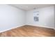 Bright and airy bedroom with wood flooring, a window, and neutral paint at 6072 Wingedfoot Ct, Indianapolis, IN 46254