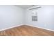 Neutral bedroom features hardwood floors and a window, offering ample light at 6072 Wingedfoot Ct, Indianapolis, IN 46254