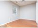 Inviting bedroom with hardwood floors, a window, and neutral wall paint at 6072 Wingedfoot Ct, Indianapolis, IN 46254