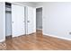 This bedroom features wood floors, neutral walls, and a closet with sliding doors at 6072 Wingedfoot Ct, Indianapolis, IN 46254