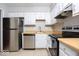 This kitchen offers white cabinets, stainless steel appliances, and natural light at 6072 Wingedfoot Ct, Indianapolis, IN 46254
