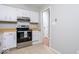 Efficient kitchen layout with modern appliances, tile flooring, and neutral cabinets at 6072 Wingedfoot Ct, Indianapolis, IN 46254