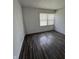 A modest bedroom featuring wood flooring, a double window, and neutral wall paint at 3231 W State Road 32, Westfield, IN 46074