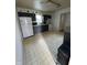 A kitchen featuring dark cabinets, tile flooring, and a bright white refrigerator at 3231 W State Road 32, Westfield, IN 46074