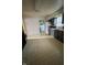 Kitchen featuring tile floor, dark cabinets, and white appliances with laundry room beyond at 3231 W State Road 32, Westfield, IN 46074