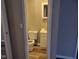 Bathroom with toilet, sink, vanity, mirror, and neutral colored walls at 309 S Fleming St, Indianapolis, IN 46241