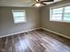Bedroom featuring wood-look flooring, ceiling fan and natural light from two windows at 309 S Fleming St, Indianapolis, IN 46241