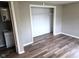 Bedroom featuring wood-look flooring and closet space at 309 S Fleming St, Indianapolis, IN 46241