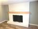 Living room boasts a white painted brick fireplace with a wood mantle at 309 S Fleming St, Indianapolis, IN 46241