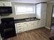 Kitchen features white cabinets, dark countertops, and stainless steel appliances at 309 S Fleming St, Indianapolis, IN 46241